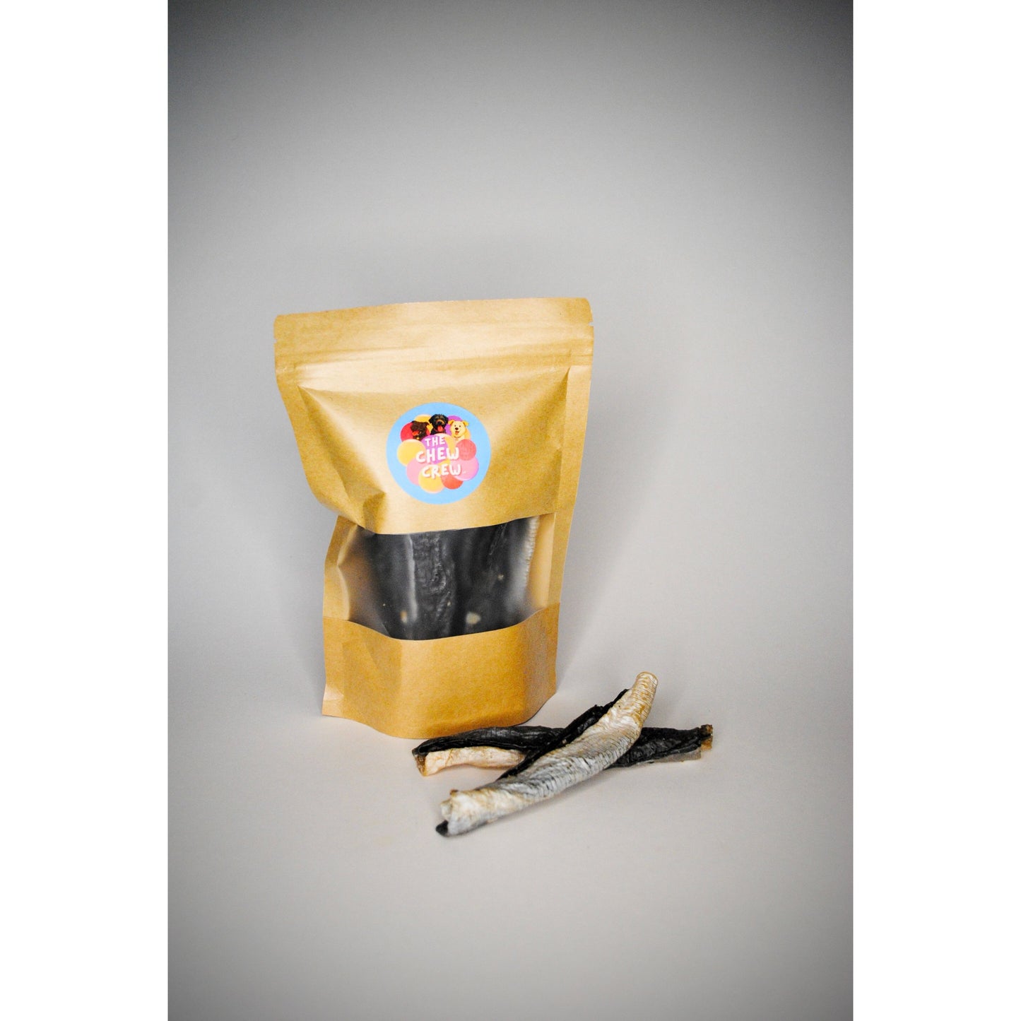 Brown packaging bag with a label containing dried fish on a gray background